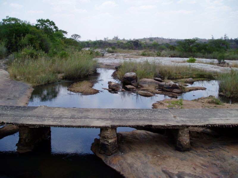 View downstream from the bridge itself, with the low-level bridge in the foreground.